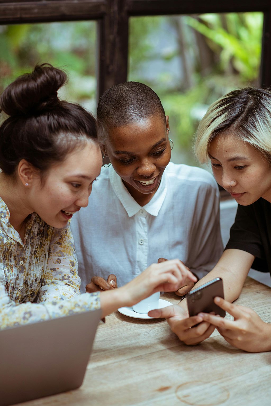 Three women looking at a cell phone screen
